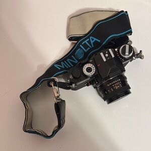 Black Digital Camera with Textured Grip and Durable Strap